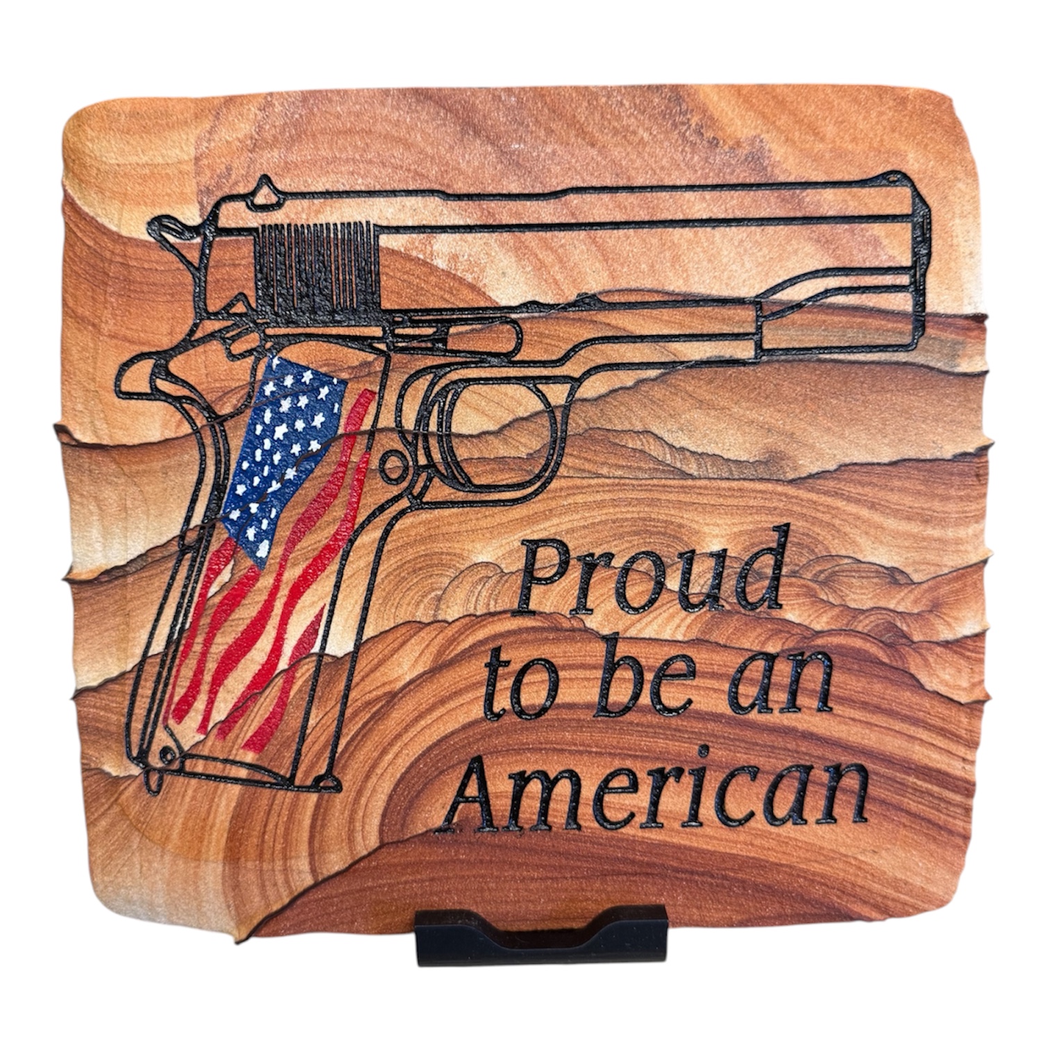 Sandstone artwork with a patriotic pistol engraving and Proud to be an American lettering